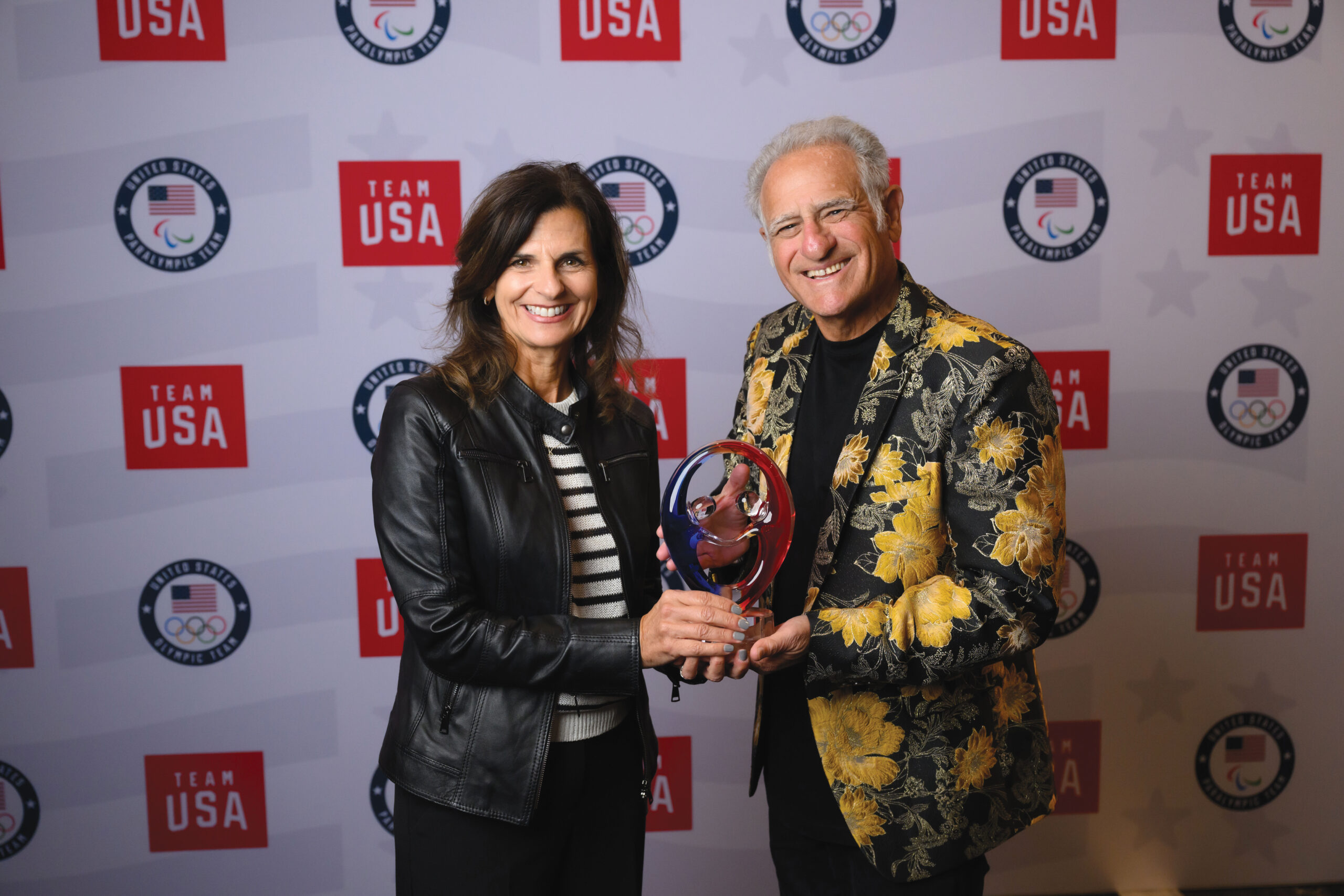 Challenged Athletes Foundation Chief Executive Director Kristine Entwistle and Co-founder Bob Babbitt celebrate CAF’s 2026 Rings of Gold – Program Award from the U.S. Olympic & Paralympic Committee, recognizing its commitment to expanding access to sport and helping athletes with physical disabilities pursue their Paralympic dreams.